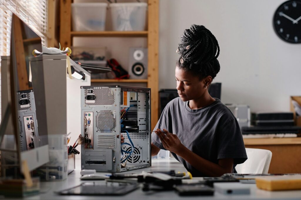 African American Woman Repairing System Unit of Computer in Workshop