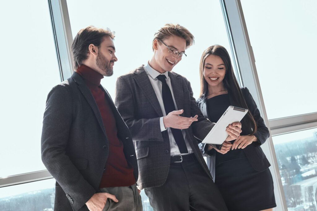 Businesspeople at office working together standing man showing p