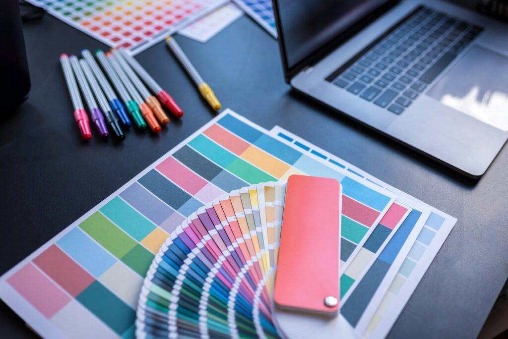 Color swatches of graphic designers putting on desk table.