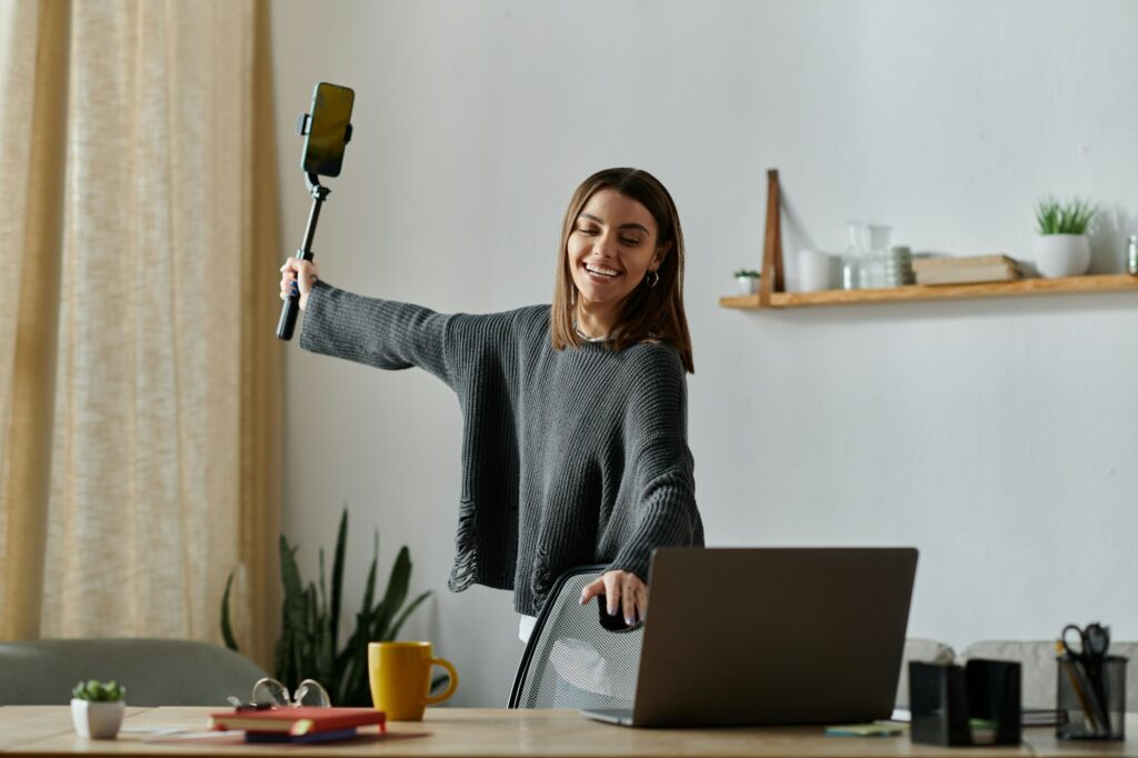 Content creation at home: a young woman films with a selfie stick