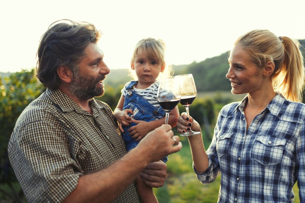 Picture of people tasting red wine in vineyard