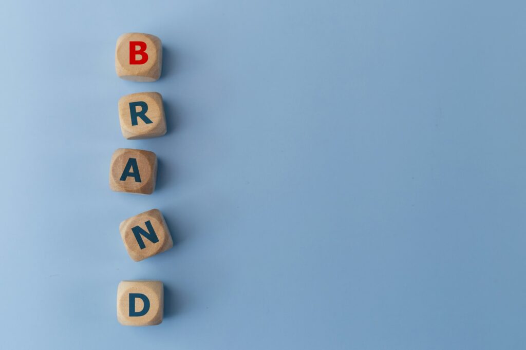 Word BAND on wooden cubes on a blue background. Business concept. Brand identity